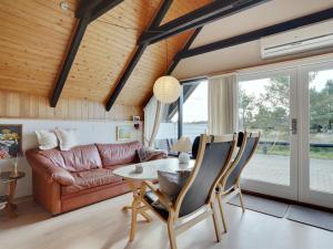 a living room with a table and a couch at Holiday Home Gerdis - 1-6km from the sea in Western Jutland by Interhome in Blåvand