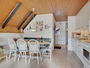 a kitchen and dining room with a table and chairs at Holiday Home Gerdis - 1-6km from the sea in Western Jutland by Interhome in Blåvand