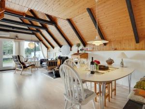 a kitchen and living room with a table and chairs at Holiday Home Gerdis - 1-6km from the sea in Western Jutland by Interhome in Blåvand