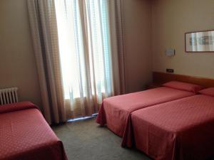 Postel nebo postele na pokoji v ubytování Hotel Pelayo