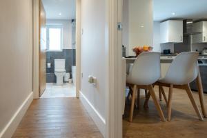 a kitchen and dining room with a table and chairs at James Charles Apartments in Milton Keynes