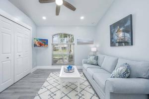 a living room with a couch and a table at Once Upon A Tide - Cape Coral in Cape Coral