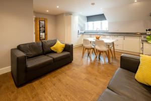 a living room with a couch and a table at James Charles Apartments in Bletchley