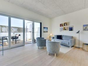 a living room with a couch and chairs and a table at Apartment Aiana - 250m from the sea by Interhome in Ringkøbing