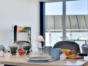 a wooden table with food on top of it at Apartment Aiana - 250m from the sea by Interhome in Ringkøbing +24 photos