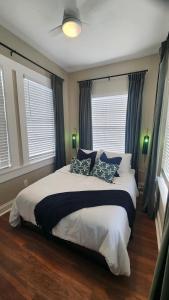 a bedroom with a large white bed with blue pillows at Updated Condo in Heart of Tampa 2 in Tampa