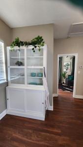 un gran armario blanco en una sala de estar con suelo de madera. en Updated Condo in Heart of Tampa 2, en Tampa