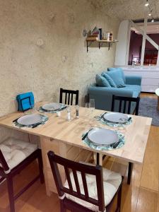 a wooden table with chairs and a dining room at Troglodyte du Petit Coteau in Vouvray