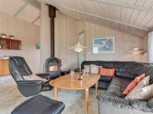 a living room with a couch and a table at Holiday Home Tuure - from the sea in Western Jutland by Interhome in Bjerregård