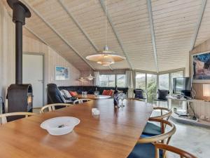 a dining room with a wooden table and chairs at Holiday Home Tuure - from the sea in Western Jutland by Interhome in Bjerregård