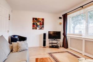 a living room with a couch and a flat screen tv at Cosy 3 Bed in the heart of Chester in Chester