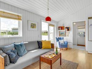a living room with a couch and a table at Holiday Home Köbes - 200m from the sea by Interhome in Ringkøbing