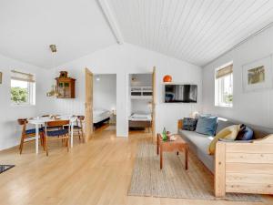 a living room with a couch and a table at Holiday Home Köbes - 200m from the sea by Interhome in Ringkøbing