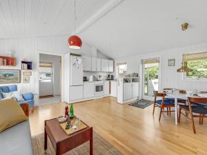 a living room with a couch and a table at Holiday Home Köbes - 200m from the sea by Interhome in Ringkøbing +22 photos