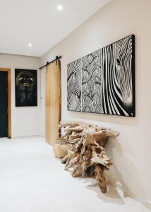 a room with paintings on the wall and a tree stump on the floor at Tulum Beach Resort Dakhla in Dakhla