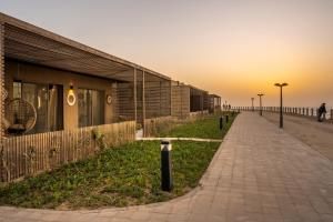 a sidewalk next to a building on the beach at Tulum Beach Resort Dakhla in Dakhla