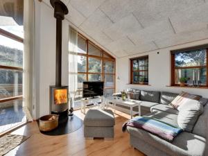 uma sala de estar com um sofá e uma lareira em Holiday Home Sila - 800m from the sea in Western Jutland by Interhome em Hvide Sande