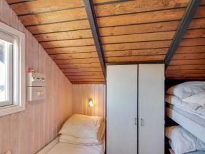 a small room with two beds and a ceiling at Holiday Home Hildegart - from the sea by Interhome in Bjerregård