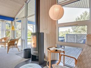 a living room with a fireplace in a house at Holiday Home Andrie - 800m from the sea in Western Jutland by Interhome in Hvide Sande