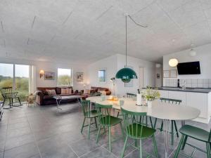 a living room with a table and chairs at Holiday Home Pontus - 400m from the sea by Interhome in Torsted
