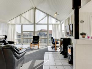 a living room with a couch and chairs and a tv at Holiday Home Gottfreda - 330m to the inlet in Western Jutland by Interhome in Havrvig