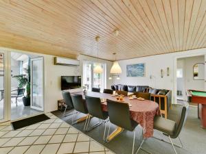 a dining room and living room with a table and chairs at Holiday Home Thana - 1-4km from the sea by Interhome in Ulfborg