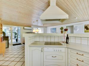 a kitchen with white cabinets and a ceiling at Holiday Home Thana - 1-4km from the sea by Interhome in Ulfborg