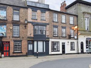 a group of brick buildings on a city street at Hogwood Cottage in Knaresborough