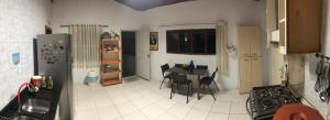 a kitchen with a table and chairs and a refrigerator at Voila Hostel in Florianópolis