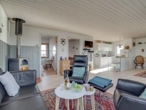 a living room with a couch and chairs and a table at Holiday Home Soyala - 400m from the sea in Western Jutland by Interhome in Harboør