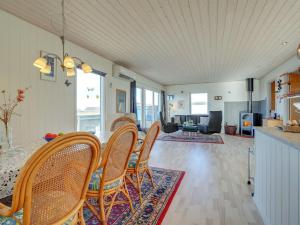 a living room with a table and chairs at Holiday Home Soyala - 400m from the sea in Western Jutland by Interhome in Harboør