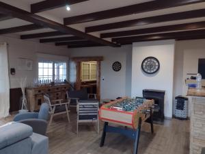 a living room with a table with a chessboard on it at Gîtes BEL'M in La Bresse