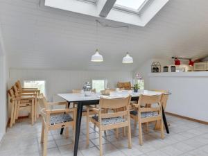 a dining room with a table and chairs at Holiday Home Luzy - 600m from the sea in NW Jutland by Interhome in Torsted