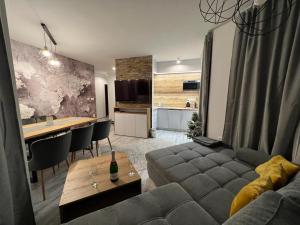 a living room with a couch and a table at Apartmány Romantika 7 19 CHOPOK JUH Lux in Horná Lehota