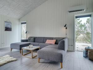 a living room with a couch and a table at Holiday Home Helli - 650m from the sea in NW Jutland by Interhome in Torsted