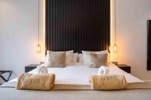 a bedroom with a large bed with towels on it at Casa Bodhi Boutique Hotel & Spa in Marbella