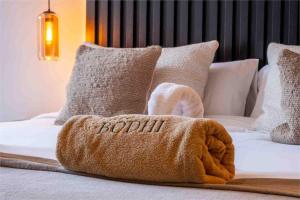 a towel sitting on top of a bed at Casa Bodhi Boutique Hotel & Spa in Marbella