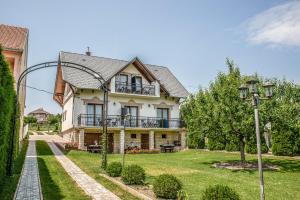 a house with a garden and a street light at Laky Villa Zalakaros in Zalakaros