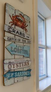 a sign on a wall with a crab on it at The Heworth Inn in York