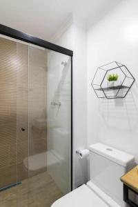 a bathroom with a toilet and a glass shower at Contemporary Studio - GRU in Guarulhos