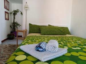 a bed with a blanket and a towel on it at Il Nido della Quaglia in Pozzuoli