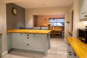 a kitchen and dining room with a counter and a dining table at Harrogate Victorian Luxury in Harrogate