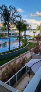 a view from the balcony of a resort with palm trees at Apartamento linda vista no Brisas do Lago, Brasília in Brasília