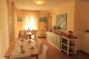 a kitchen and dining room with a table and chairs at La Piazzetta in Numana