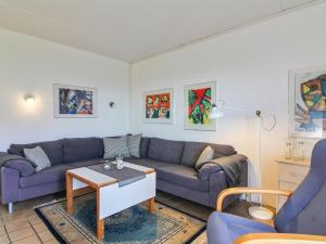 uma sala de estar com um sofá e uma mesa em Apartment Tinke - 150m from the sea in NW Jutland by Interhome em Lokken