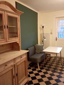 a living room with a chair and a table at Obergeschoss - Katharina von Berg in Rottweil