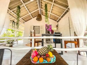 a plate of fruit on a table in a room at Villa Wonderworld Resort in Ban Nua