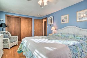 a bedroom with a bed and a blue wall at Walk to Great Pond Spacious East Falmouth Home in East Falmouth