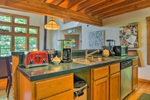 a kitchen with a sink and a counter top at Forested Pentwater Vacation Rental - Walk to Beach in Pentwater +23 photos