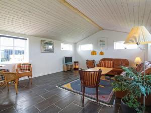 a living room with a couch and a table at Holiday Home Fabio - 450m from the sea in NW Jutland by Interhome in Løkken